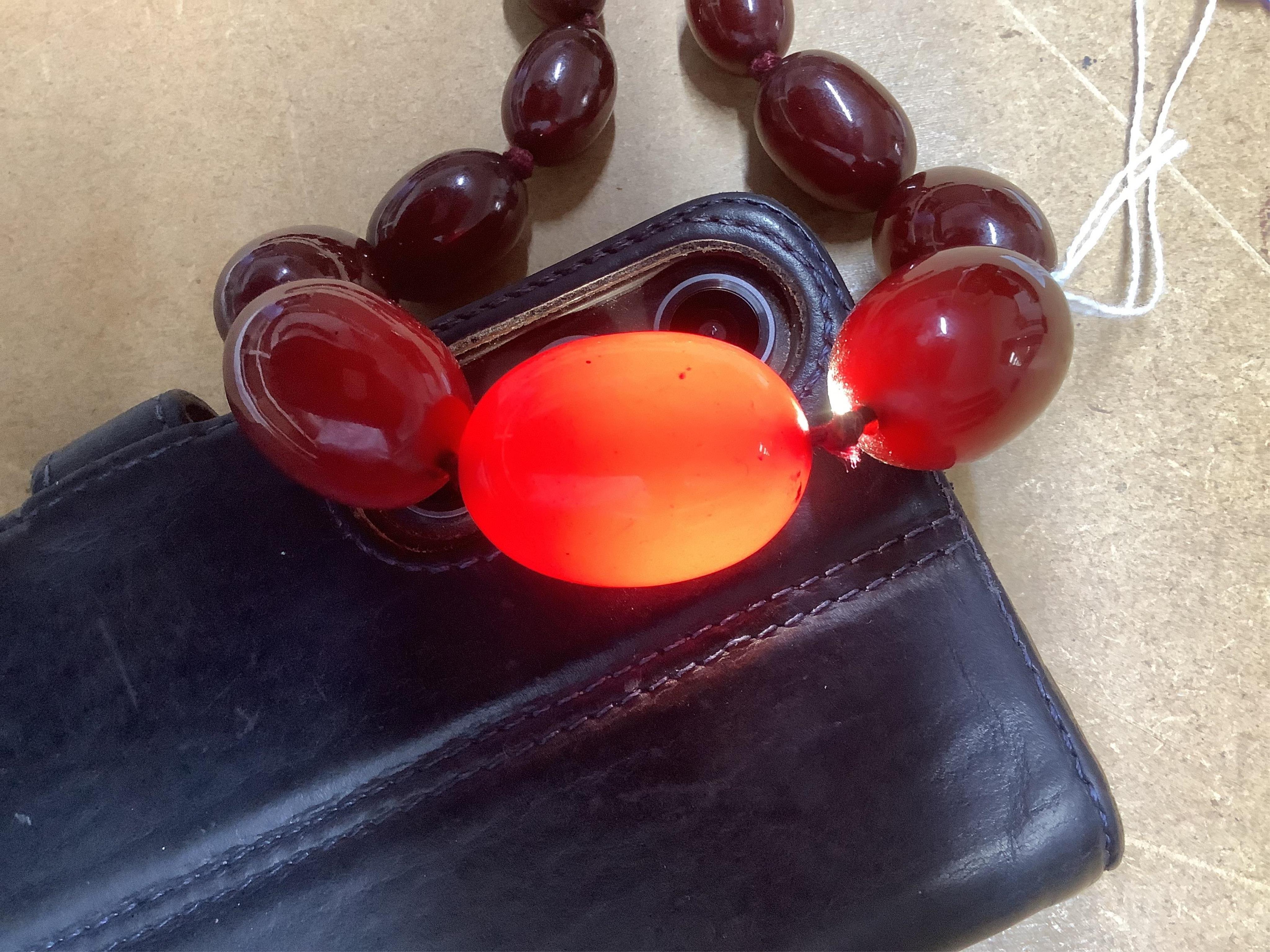 A single strand simulated cherry amber bead necklace, with graduated oval beads, 72cm, gross weight 73 grams.